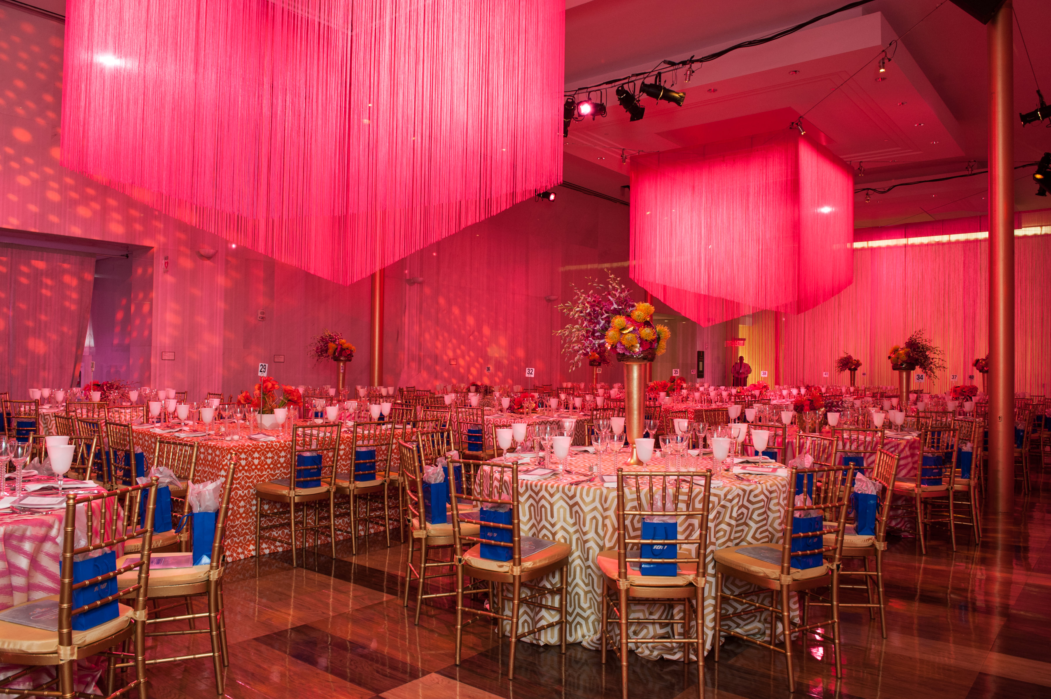 Pink string fringe curtains used in a commercial event installation, showcasing custom decorative backdrops by GenerationStore.com.